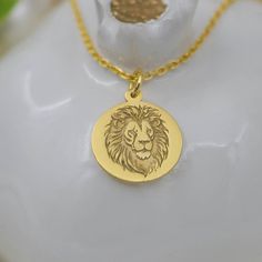 Embrace the Majesty of the Lion with Our 14K Solid Gold Lion Head Necklace Our 14K Solid Gold Lion Head Necklace captures the essence of the majestic lion, a timeless symbol of strength, courage, and royal authority. Crafted with exquisite detail, this stunning piece is perfect for anyone who admires the king of the jungle. Features: Material: High-quality 14K solid gold Design: Intricately detailed lion head pendant Style: Animal, Majestic, Symbolic Pendant Size: (specify size) Chain Length: (s Safari Jewelry, Lion Head Necklace, Majestic Lion, Symbol Of Strength, Jewelry King, Lion Pendant, King Of The Jungle, Head Necklace, Face Pendant