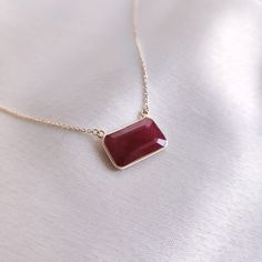 "This stunning pendant is set in 14k Solid Yellow Gold with Natural Ruby with utmost precision. It is an unique gemstone pendant for nearly every occasion and is completely hassle-free jewelry. ITEM DETAILS: * Gem: Ruby  * Gem Size: 8.5x4mm * Gem Shape: Octa Rectangle * Gem Weight: 5.28 carats * Gold Purity: 14KT * Gold Weight: 1.15 gram * Total Weight of the Pendant: 2.21 gram * Chain Length: 16\" Inches The Gold purity is guaranteed and it comes with authentic 14KT gold hallmark. Since my items are handmade, they are absolutely nickel and lead free. CUSTOMIZATION: * Gemstone customization is available and it can be substituted with a gem of your choice. Kindly message me for the same. * Chain length is customizable as well. Kindly message me for the same. PACKAGING * The Pendant comes wi Elegant Custom Necklace With Polished Finish For Gift, Ruby Gemstone Jewelry Gift, Fine Jewelry Rectangular Pendant As Gift, Classic Necklace With Rectangular Stone As Gift, Rectangular Gemstone Necklace For Anniversary, Luxury Ruby Jewelry Gift, Elegant Birthstone Necklace With Polished Finish As Gift, Gift Ruby Jewelry With Polished Finish, Classic Faceted Gemstones As Gifts