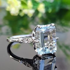 a fancy ring with an emerald and diamond center stone