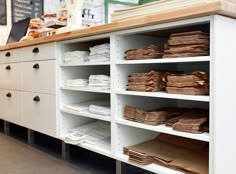 the shelves are full of files and papers in the store's front desk area