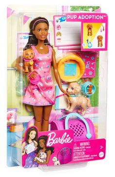 the barbie doll is in her pink outfit and has two pups on it's back