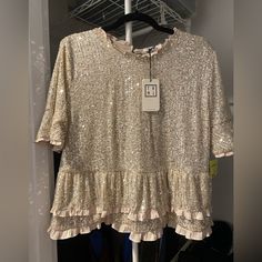 Fun, Flattering Sequin Top. Fits More Like An 8/10. Chic Tops With Ruffle Hem For Party, Chic Party Tops With Ruffle Hem, Fitted Party Tops With Ruffle Hem, Ruffle Hem Tops For Spring Night Out, Ruffle Hem Top For Night Out In Spring, Fitted Ruffle Hem Top For Party, Spring Ruffle Hem Top For Night Out, Feminine Party Blouse With Ruffle Hem, Glamorous Gold Tops For Spring