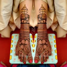 the legs and feet of a woman with henna tattoos