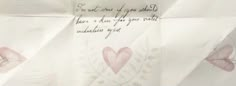 a piece of paper that has some writing on it with flowers and hearts drawn on it