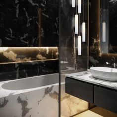 a modern bathroom with marble counter tops and black walls, along with a large white bowl sink