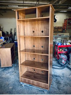 a wooden bookcase sitting inside of a garage