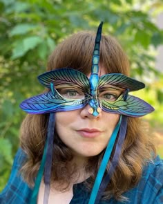 Invoke your inner fae with this one of a kind leather dragonfly masquerade mask handmade by the artist Alexis Burbank. The layers of iridescent pigment in this mask truly shine in the sun! This mask is made from genuine leather which is both light and flexible, so that they fit on all face shapes while also being sturdy and breathable- making it extremely comfortable to wear for special events. It can be mounted on your wall to double as decor while not being worn. This mask is ready to ship. Pl Dragonfly Masquerade Mask, Face Mask Costume Ideas, Nature Masquerade Mask, Masquerade Mask With Glasses, Custom Mask Ideas, Animal Masks Masquerade, Dragonfly Costume, Masquerade Mask Ideas, Leather Dragonfly