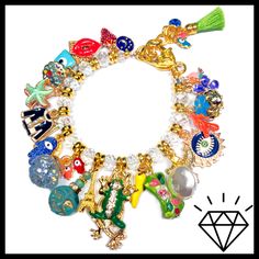 "LOADED gold charm bracelet just the way you like it with the addition of Crystals!! Tons of enamel charms with Czech crystals in between! Stunning! 7 3/4\" length with Lobster Clasp and adjustment chain. Actual charms may vary. All of my jewelry is handmade by me. No two are exactly alike. Hence the name, \"OKO by Andy\" (One-of-a-Kind). The photos in the listings are indicative of the style you will receive, not necessarily an exact representation since these are not mass made in a factory." Gold Charm Bracelet As A Souvenir, Gold Enamel Bracelets With Charms, Gold Enamel Bracelet With Charms, Enamel Charms Bracelet, Gold Charm Bracelet, Czech Crystal, Enamel Charms, Just The Way, Gold Charm