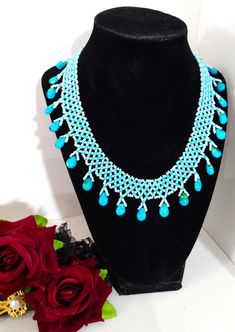 A handmade glass beaded necklace that is perfect for any occasion: parties, weddings, holidays, birthdays, anniversaries. All products are hand-crafted by my mother. Dimensions: - Length: 15.6 cm - Width: 14.5 cm - Height: 2.0 cm Lightweight, high quality with a hook as a clasp. Will respond to concerns and suggestions promptly. Shipping costs: Free Domestic Shipping. All orders are sent by air-mail with tracking number. Time of delivery: Estimated 2-5 days for domestic shipping; international may take 7-14 days. Feel free to check out our other similiar products! Link: https://www.etsy.com/shop/NurKnitsNKrafts Traditional Blue Beaded Necklaces For Party, Handmade Turquoise Beaded Necklaces With Round Beads, Turquoise Beaded Chain For Party, Blue Beaded Bridal Necklace With Round Beads, Festive Turquoise Necklaces With Colorful Beads, Blue Beaded Bridal Necklace For Party, Turquoise Beaded Jewelry For Party, Turquoise Beaded Jewelry For Celebration, Festive Turquoise Beaded Jewelry