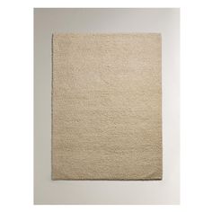 a beige rug on a white wall