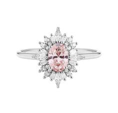 a pink diamond ring with white diamonds on the band and an oval center stone in the middle