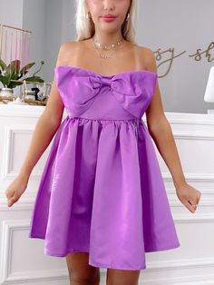 Meet the Regal Ribbon Bow Dress from Sassy Shortcake! This vibrant purple dress features a charming bow and a flattering strapless design. The elegant, soft satin fabric and smocked back provide both comfort and style. Perfect for any special occasion, this dress will make you stand out in a crowd. fit: stretchy fit, runs a bit big (model wearing a size small) content: 100% polyester care: hand wash cold Satin Purple Dress, Sassy Shortcake, Patriotic Dresses, Purple Bow, Purple Bows, Bow Dress, Vibrant Purple, Shoe Gifts, Ribbon Bow