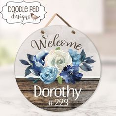 a welcome sign with flowers on it hanging from a wooden plaque that reads, do not enter