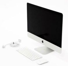 an apple desktop computer sitting on top of a white desk next to a keyboard and mouse