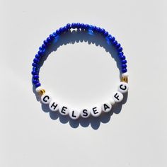 Introducing our stunning Handmade Chelsea Team Colors Bead Bracelet - the perfect accessory for any passionate Chelsea FC fan! Show your unwavering support for the Blues in style with this customizable bracelet that lets you wear your team pride on your wrist. 🔵 Features: - Handcrafted with love and care, this bracelet showcases the iconic Chelsea Women's Team Colors - the vibrant blues and white that signify excellence and dedication. - Personalize your bracelet by adding your favorite Chelsea Personalized Blue Charm Bracelet With Round Beads, Personalized White Wristbands For Team Events, Personalized White Wristband For Team Events, Casual Customized Blue Beaded Bracelets, Customizable White Wristband For Everyday, Team Spirit Letter Beads Bracelets As Gift, Team Spirit Letter Beads Bracelets For Gift, Custom Name Blue Bracelets With Round Beads, White Team Spirit Wristbands For Team Events