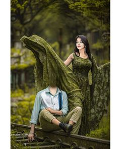 a man and woman sitting on top of a train track