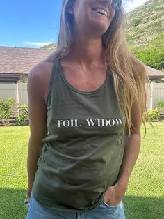 Let the wind feel the Foil Widow racer back tank! This cotton tank is designed to keep you cool, looking stylish, and feeling awesome. Perfect for a beach run or just chilling in the sun! 100% cotton graphic printed racer back tank top Trendy Racerback Cotton Tank Top, Trendy Cotton Racerback Tank Top, Casual Racerback Tank Top With Letter Print, Green Graphic Print Cotton Tank Top, Green Cotton Graphic Print Tank Top, Sleeveless Cotton Tank Top With Screen Print, Sporty Cotton Tank Top With Screen Print, Cotton Sleeveless Screen Print Tank Top, Cotton Sleeveless Tank Top With Screen Print