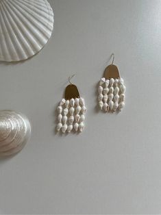 Shell Wind Chimes Earrings | Jewelry | Three Fleas Handmade White Mother Of Pearl Earrings, Handmade Unique Pearl Earrings, Unique Handmade Shell Earrings, Handmade White Earrings In Mother Of Pearl, White Shell Shaped Pearl Drop Earrings, White Shell Earrings With Pearl Drop, Pearl White Mother Of Pearl Dangle Earrings, White Shell-shaped Pearl Drop Earrings, Bohemian White Mother Of Pearl Earrings