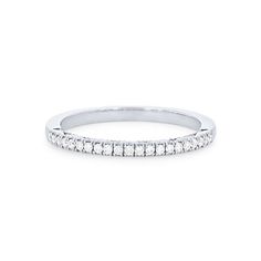 a white gold wedding band with rows of diamonds on the side, set in 18k white gold