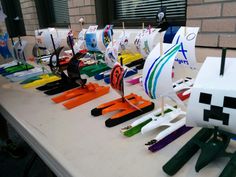 a table topped with lots of different types of paper boats