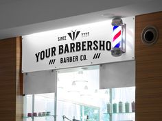 a barber shop sign hanging from the side of a wall next to a counter top