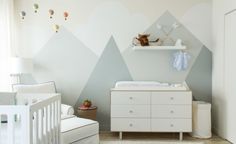 an image of a baby's room with mountains on the wall