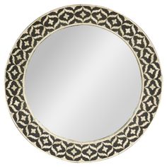 a round mirror with an ornate design on it