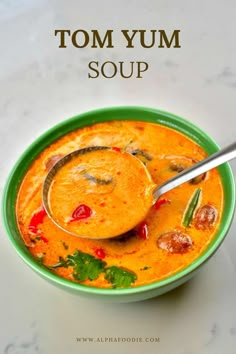 a bowl of tom yum soup with a spoon in it and the title overlay reads, tom yum soup