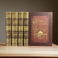 a set of five books sitting on top of a wooden table