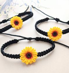 An elegant bracelet with handsculpted sunflower and handbraided black nylon cord Details Sunflower measures 0.5 inches adjustable upto 8.5 inches which can fit most wrist sizes. Sunflower Jewelry Diy, Sunflower Things, Sunflower Stuff, Jewelry For Bridesmaids, Fall Wedding Jewelry, Sunflower Accessories, Sunflower Bracelet, Sunflower Charm, Sunflower Jewelry