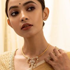 Description In this statement staple, a string of semi-precious Kundan buds come together along with a winsome blossom that is delicately rich in artistry. This gold plated silver necklace epitomises traditional grace; making it the perfect ally to your festive finery. Product Information Materials used: 925 Silver with 1.0-microns Gold Plating Stones: Semi precious stones and Semi precious jadau Length: 20.5 cm and adjustable Findings: Hook and links Elegant Temple Jewelry Kundan Necklace, 22k Gold Pearl Necklace For Celebrations And Festivals, Yellow Gold Kundan Necklace For Puja And Festive Occasions, Festive Yellow Gold Kundan Necklace For Puja, Formal Kundan Necklace With Tilla, 22k Gold Bridal Necklace For Puja, 22k Gold Jewelry For Puja, Festive Yellow Gold Kundan Pendant Necklace, Festive Elegant Tilla Necklace