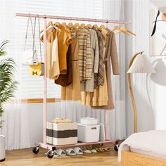 a clothes rack in a bedroom next to a bed