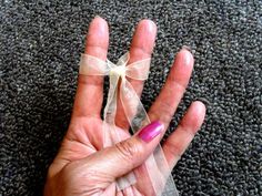 a person's hand with a ribbon around it