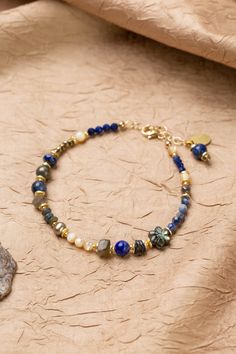 Discover the vibrant and stunning colors of the Blue Moon Collection in this eclectic bracelet! Gold Filled (Lead & Nickel Free) Pyrite, Lapis Lazuli, Sodalite, Abalone, Labradorite, Freshwater Pearl, Mother Of Pearl 7.5-8.5" adjustable length, with gold filled lobster claw clasp We hand select our natural materials, thus there may be slight variations in color and/or size that will not detract from the overall aesthetic. Our unique handcrafted designer jewelry for women is made in America, each Floyd Va, The Blue Moon, Silver Gold Earrings, Silver Gold Necklace, Pyrite Necklace, Flower Collage, Moon Collection, Pearl Design, Beaded Jewelry Patterns