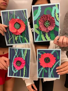 three women holding up paintings with flowers on them