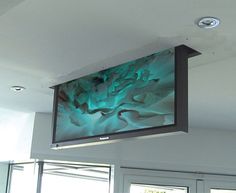 a flat screen tv hanging from the ceiling