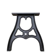 an iron stool with heart shaped holes on the top and bottom, against a white background