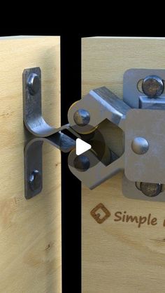 a close up of two metal latches on a wooden door with the word simple hardware