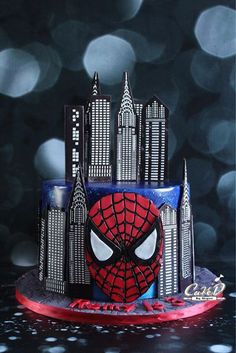 a spiderman themed cake with skyscrapers in the background