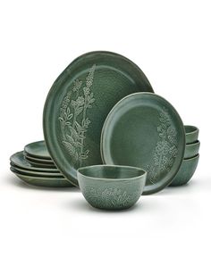 green dinnerware set with floral designs on the front and side, including one bowl