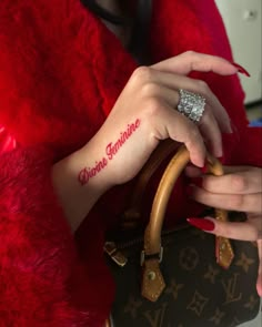 a woman wearing a red fur coat holding a brown louis vuitton bag