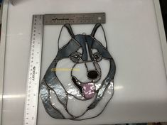 a metal cut out of a husky dog