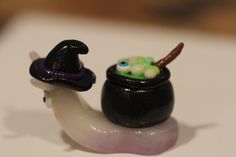 a small figurine is sitting on top of a snail