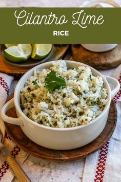 a white bowl filled with rice and garnished with cilantro limes