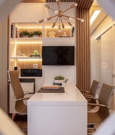 a living room filled with furniture and a flat screen tv on top of a white table