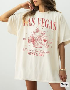 "Comfort Colors Las Vegas Bachelorette Shirt, Retro Casino Bach Club Girls Trip Tee, Personalized Luxury Bachelorette Logo, Modern Poker Dice Bachelorette Party Shirts, Vegas Before Vows, Custom Wedding Shirt, We Said Vegas, Drink and Dice Shirt ✧ WHY  YOU'LL  LOVE IT ✧  ⋒ Comfort Colors® tees are garment-dyed shirts that are timeless classics and will never pile.  ⋒ Trendy retro vintage look and gorgeous colors.  ⋒ Amazingly soft and comfy. Perfect with any shorts, skirts, jeans, leggings, or nothing but undies around the house. ⋒ Created with quality in mind, it's made from 100% ring-spun cotton. ⋒ Will last for years with its double-needle stitched neckline, sleeves, and bottom-hems. ⋒ Garment is made with the most expensive dyeing process, reducing shrinking up to 99%. ⋒Comfort Colors® Las Vegas Bachelorette Shirts, Vegas Theme Shirts, Vegas Bach Theme, Las Vegas Wedding Favors, Short Sleeve Summer Wedding Tops, Summer Wedding Tops With Short Sleeves, Short Sleeve Tops For Bridesmaids, White Short Sleeve Top For Bridesmaids, Pink Short Sleeve Top For Wedding