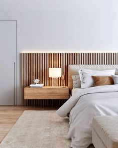 a white bed sitting next to a wooden headboard