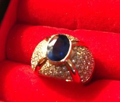 Antique ring which belonged to my late grandmother.  It deserves to be worn and appreciated for all to admire!  This heirloom ring consists of a 24k gold band, an oval-cut blue sapphire, which is surrounded by diamonds. This is a beautiful and unique piece of jewelry to add to one's collection. Appraised at over $12,000, I am asking only 2/3 of the rings true value. Formal descriptions by certified gemologist can be seen in picture of appraisal on this listing. Gold Oval Cabochon Sapphire Ring For Formal Occasions, Formal Gold Oval Cabochon Sapphire Ring, Gold Sapphire Ring With Oval Cabochon For Formal Events, Formal Gold Sapphire Ring With Oval Cabochon, Luxury Diamond Ring With Stone Setting For Formal Events, Gold Oval Cabochon Diamond Ring For Formal Occasions, Gold Diamond Ring Oval Cabochon For Formal Occasions, Formal Gold Diamond Ring With Oval Cabochon, Gold Oval Sapphire Ring With Brilliant Cut