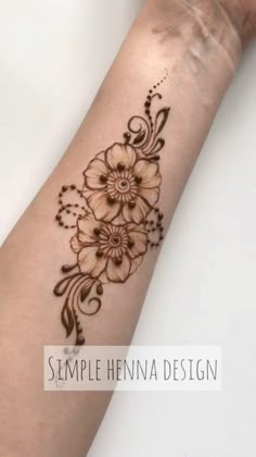 a woman's arm with a flower tattoo on it, and the words simple henna design