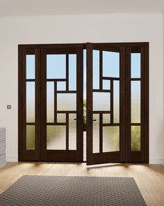 an empty room with two double doors and a rug on the floor next to it